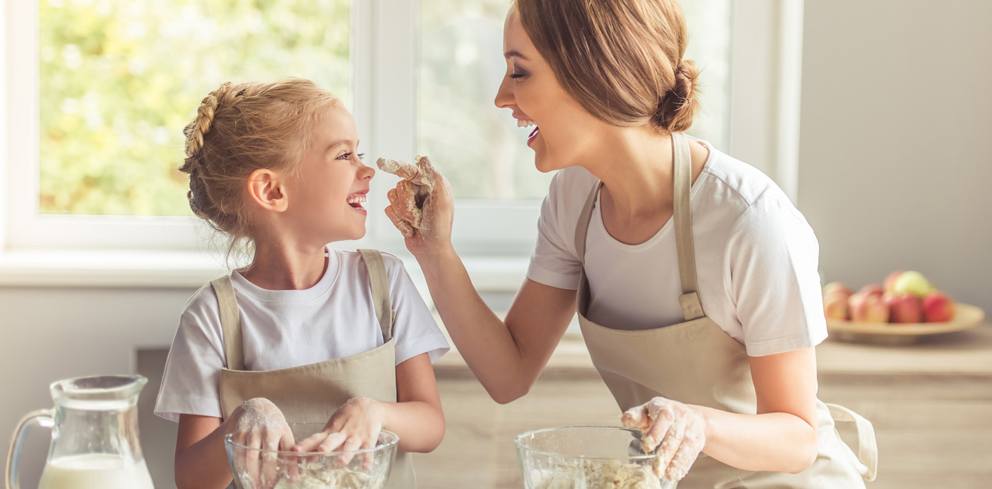 Mom and daughter bake together.