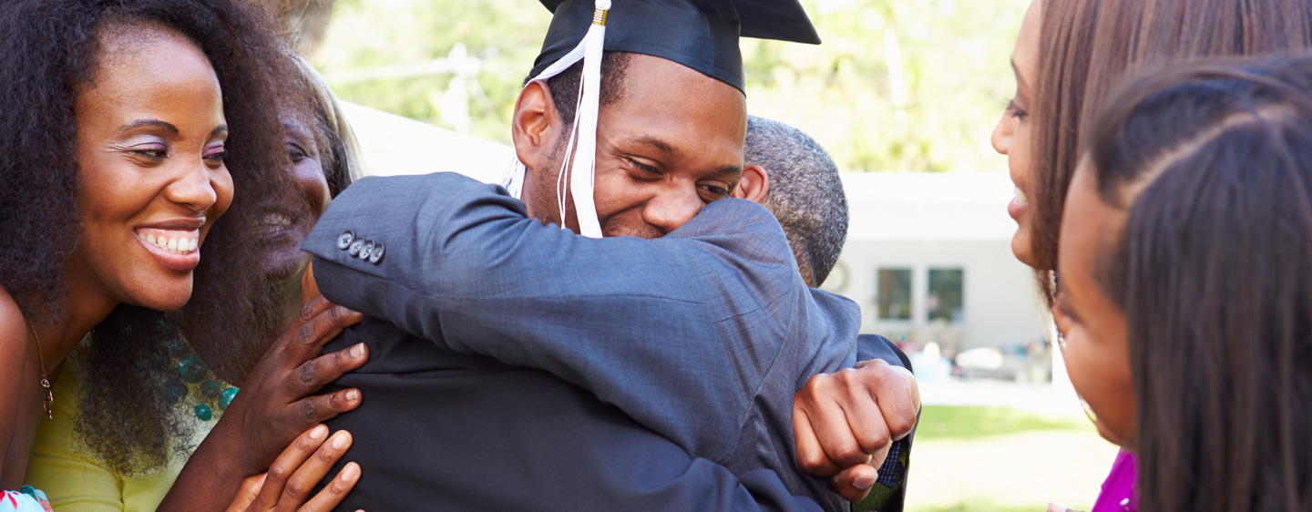 A graduate hugs a family member.
