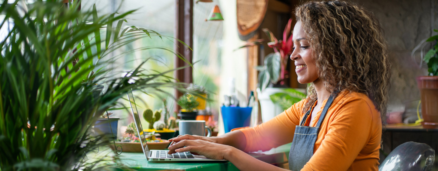 Image of an African American woman doing work on her laptop.