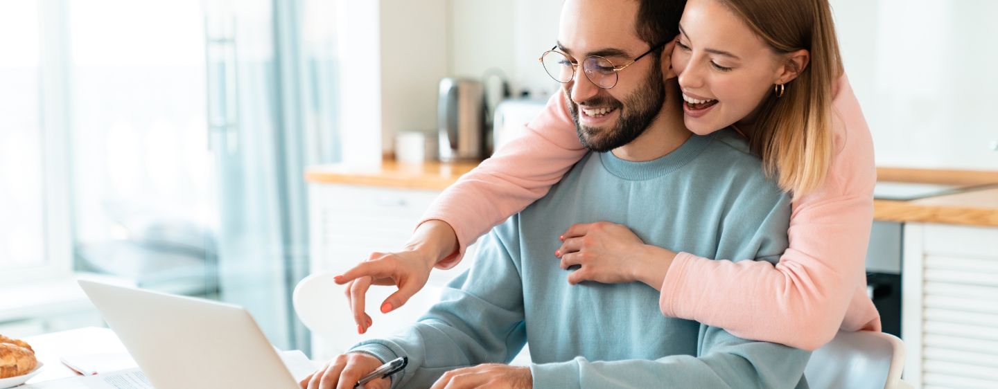 Couple smiling at computer