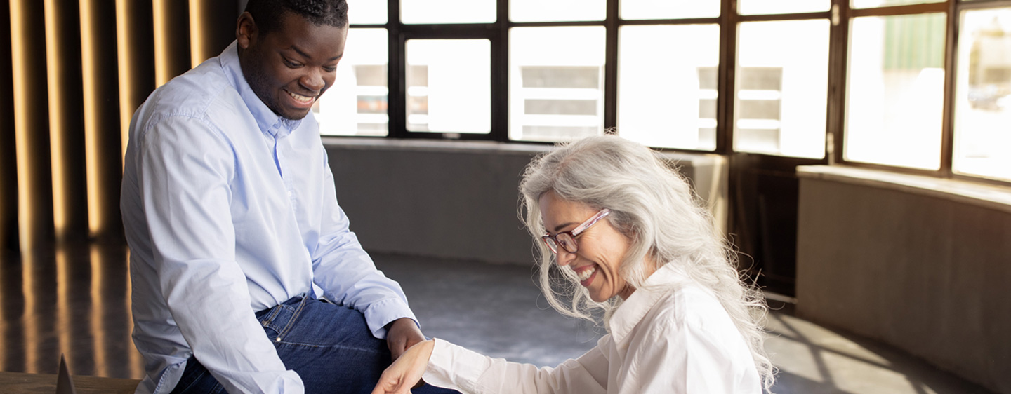 A younger man and older woman review her will together.