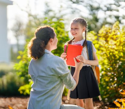 Mom sending daughter back to school. 