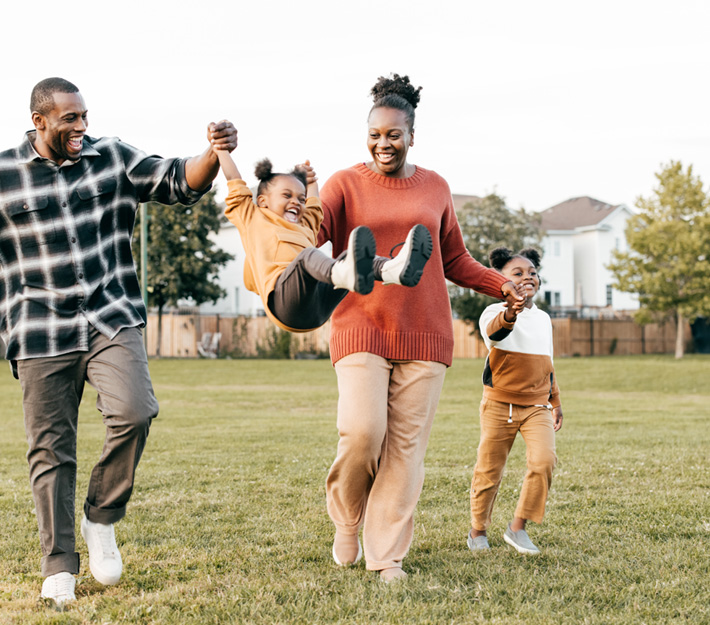 A family plays together in their yard