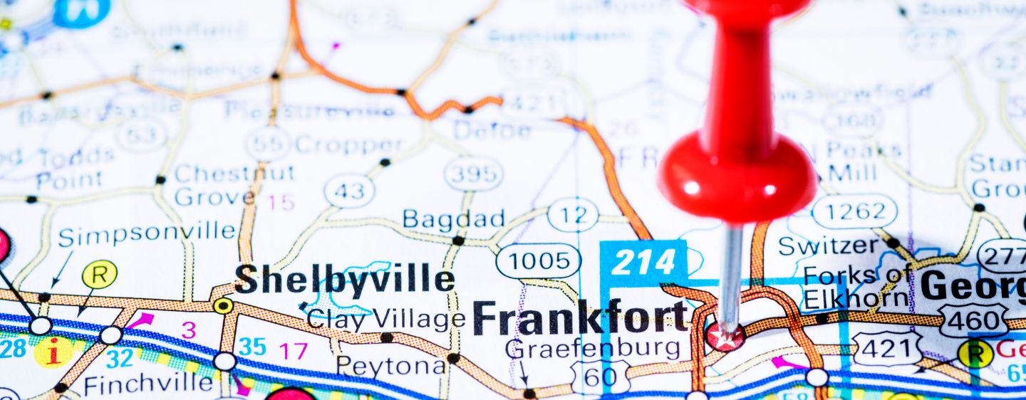 Zoomed-in photo of a map of KY with a push pin inserted in Frankfort.