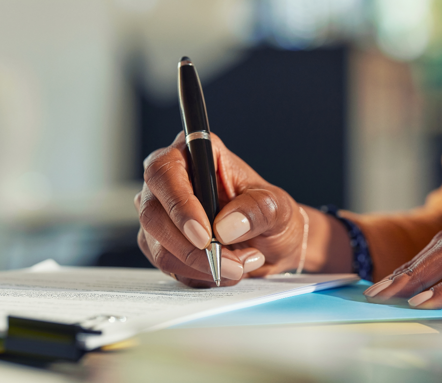 Individual signing paper.