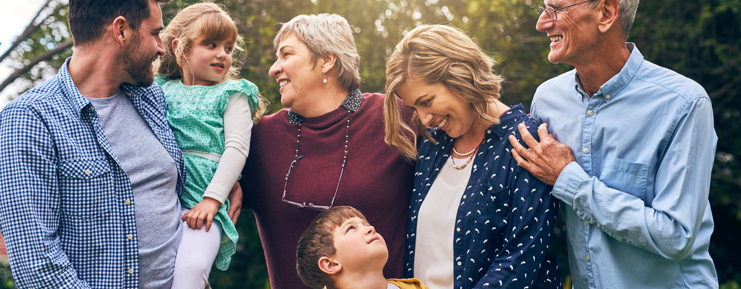 Family poses together outside